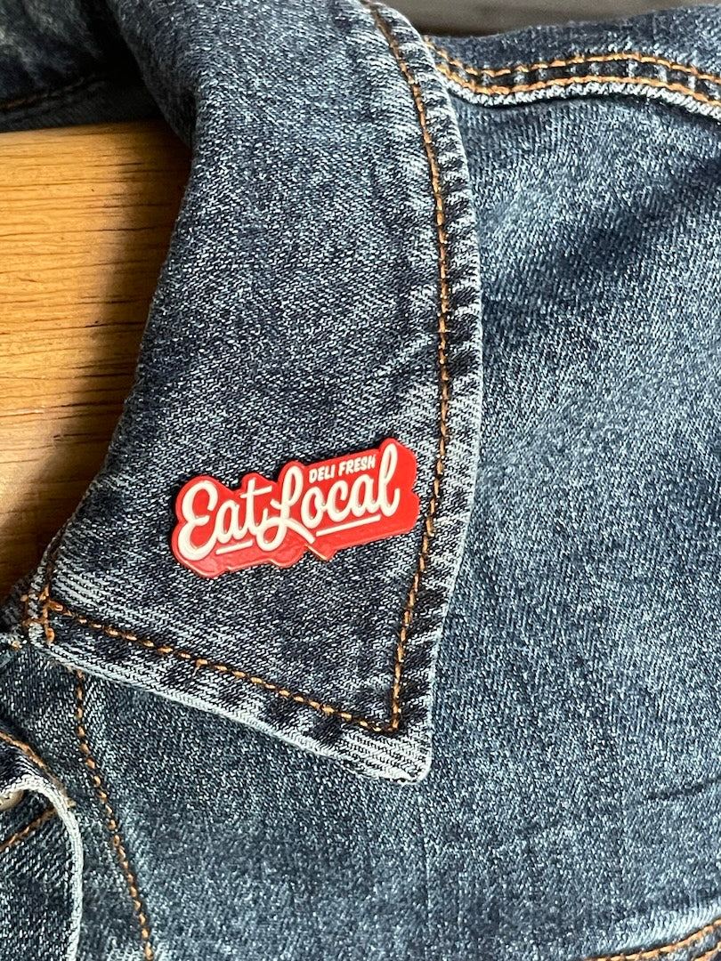 Eat Local Enamel Pin on a jacket