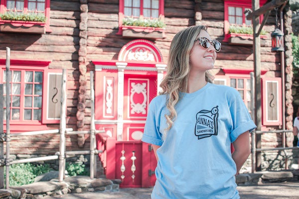 Girl wearing Anna's Sandwich Shop T-shirt in front of Arrendelle