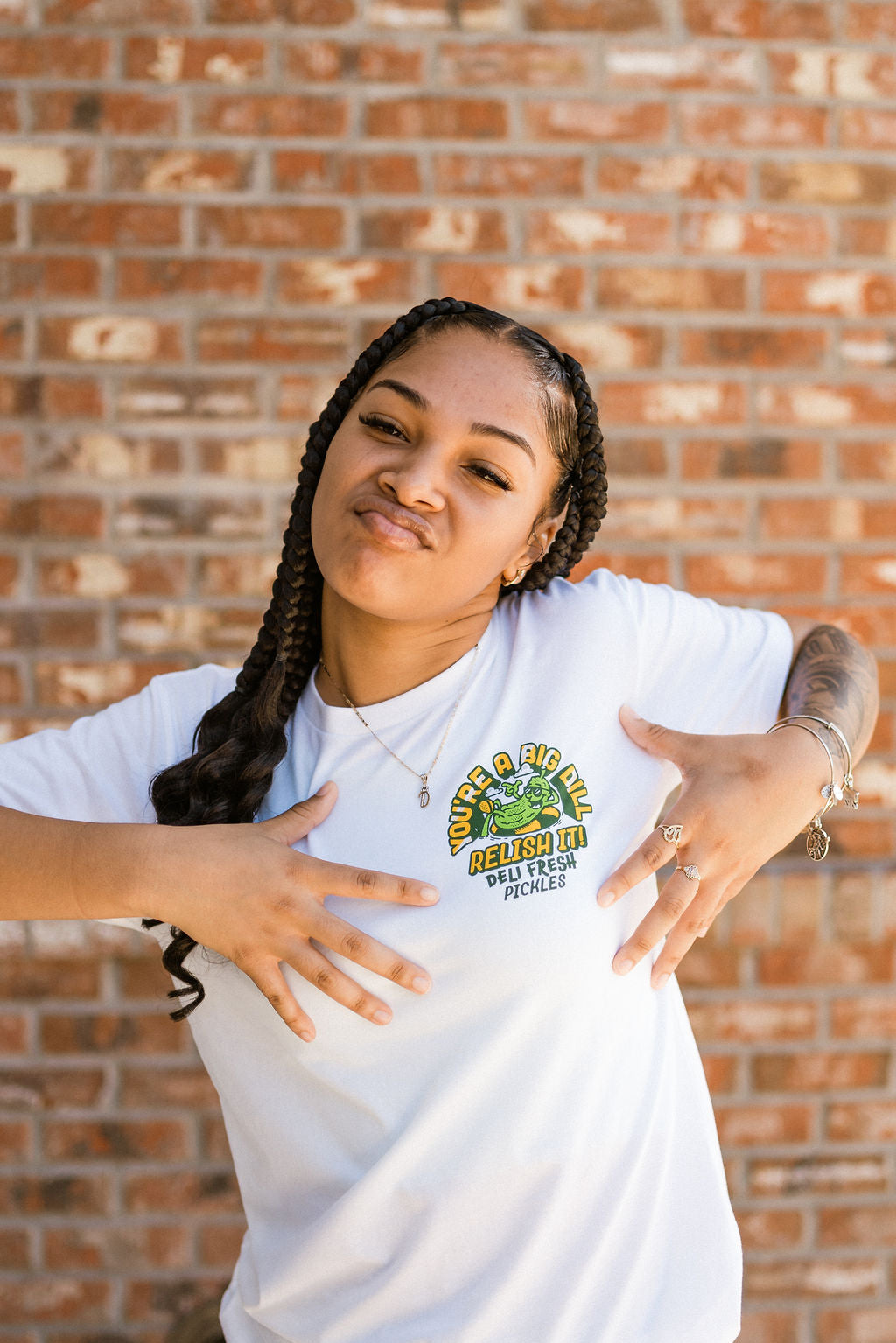 Girl showing off the front of the Big Dill T-shirt- You're a Big Dill