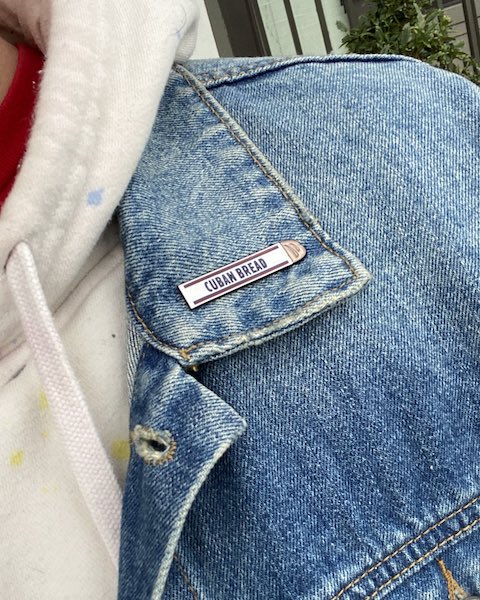 Cuban Bread enamel pin on a jean jacket