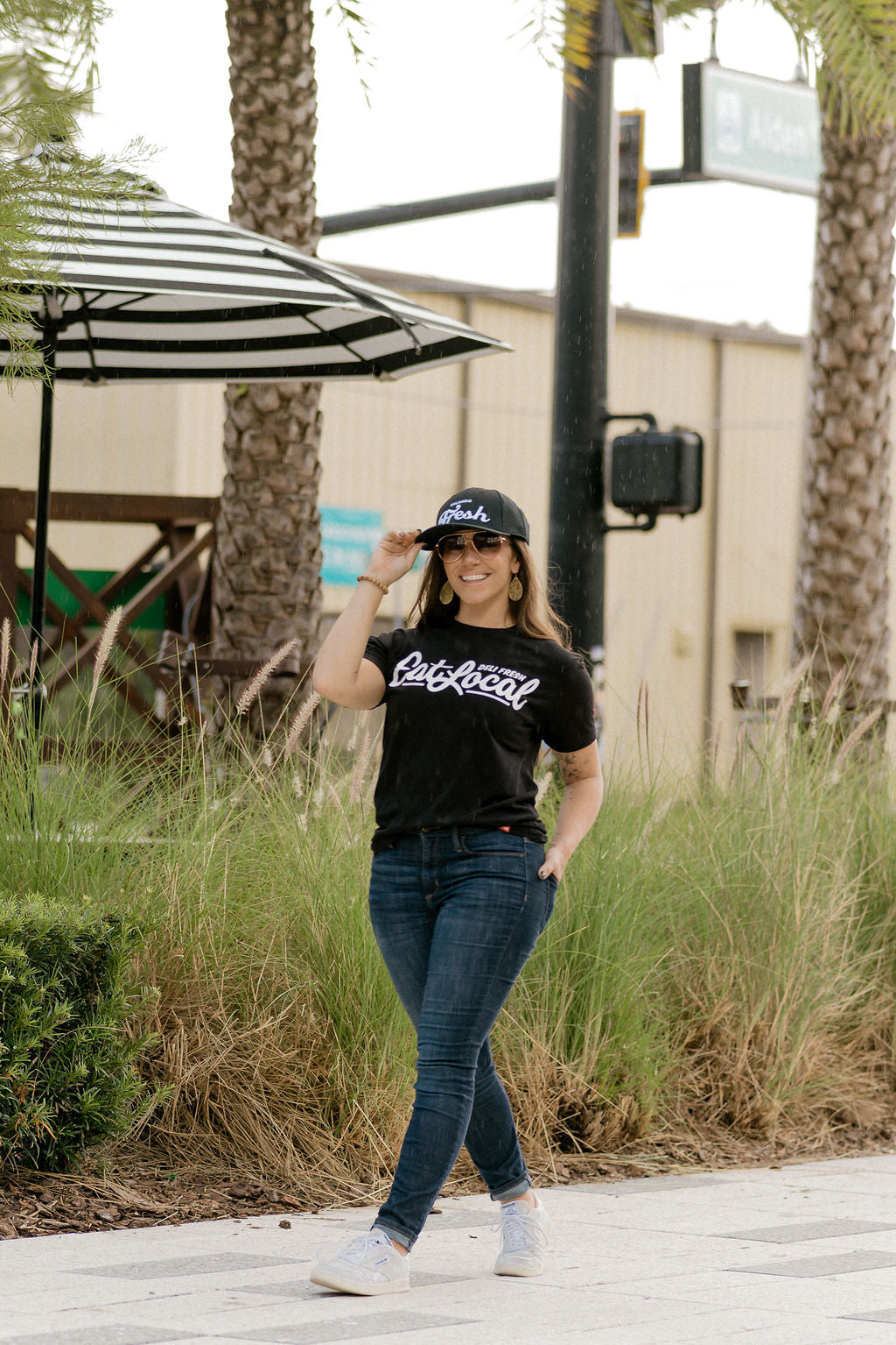 Girl smiling wearing a Black Eat Local T-shirt