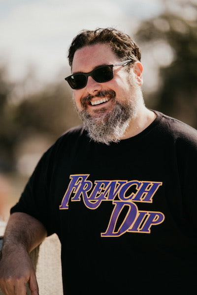 Guy smiling wearing a black Los Angeles French Dip Sandwich T-shirt