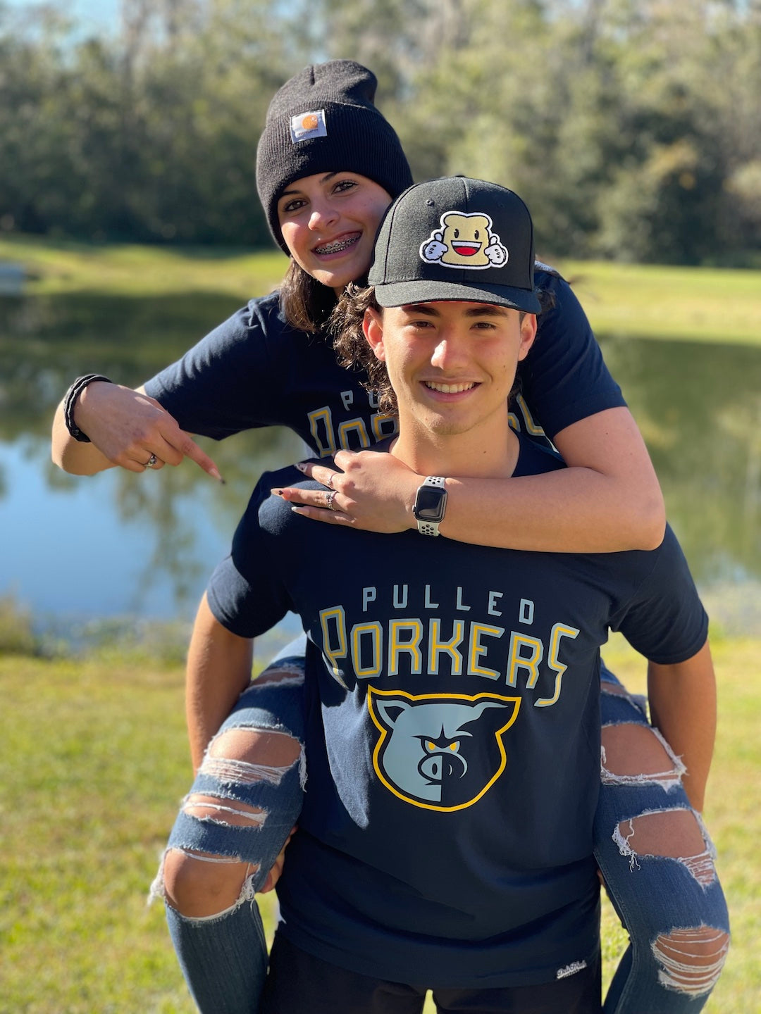 Guy and girl wearing Memphis Pulled Pork sandwich shirts