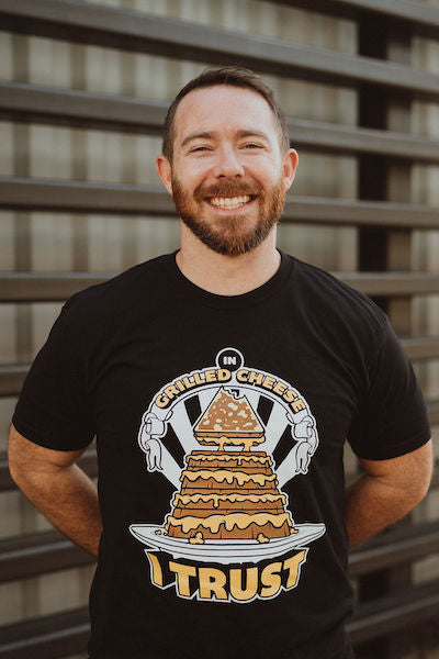 Guy smiling wearing In Grilled Cheese I Trust T-shirt