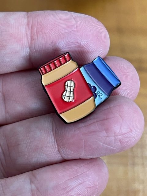 Cloesup of the peanut butter and jelly heart enamel pin