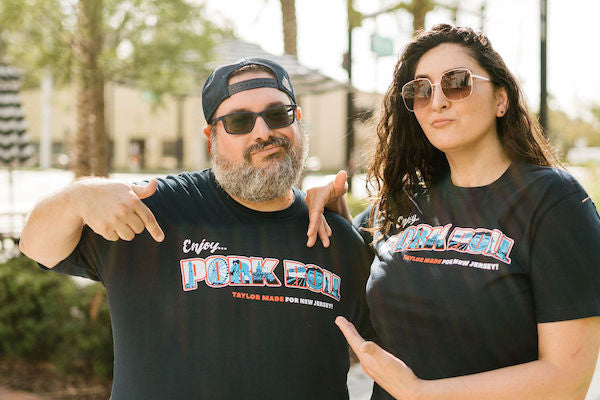 Guy and girl wearing New Jersey Taylor Ham Pork Roll shirt