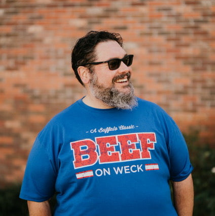 Guy wearing a Buffalo Beef on Weck T-shirt outside.
