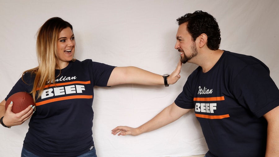 Guy and girl posing with a football wearing Chicago Italian Beef T-shirt