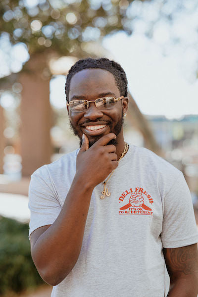 Guy showing off the front of the Hot Dog and Sandwich high fiving - It's Ok to be Different both are delicious 