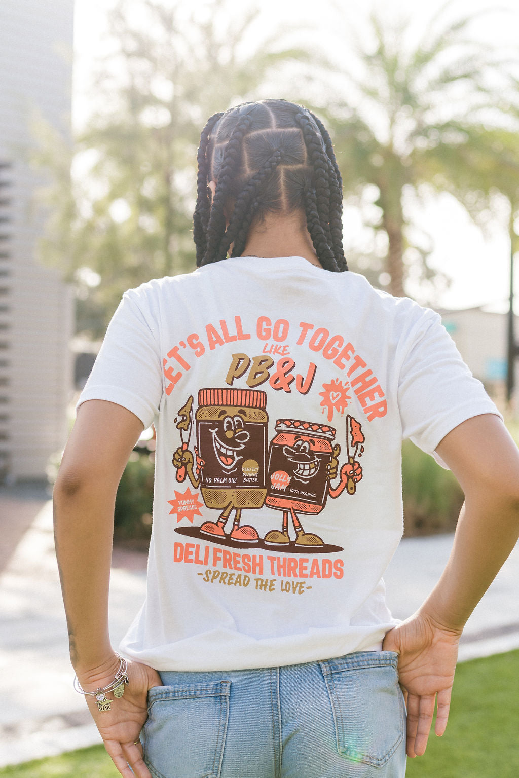 Back view of girl wearing Let's All go together like PB&J Spread the love T-shirt 