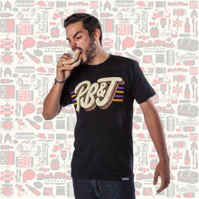Load image into Gallery viewer, Guy wearing a Peanut Butter and Jelly T-shirt eating a PB&amp;J sandwich
